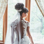 bridal hairstyle updo with curls and veil back view