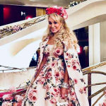 suzanne rogers with long curly hair and floral crown